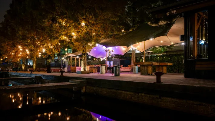 Evening setup on the water at Strandzuid, string lights and a stretch-tent canopy